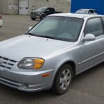 1506px-2006_Hyundai_Accent_GS_hatchback_in_Clean_Silver_Metallic_Front_Left_10-08-2022